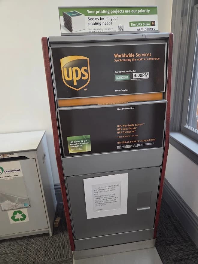 Indoor UPS drop box with a slot for outgoing packages
