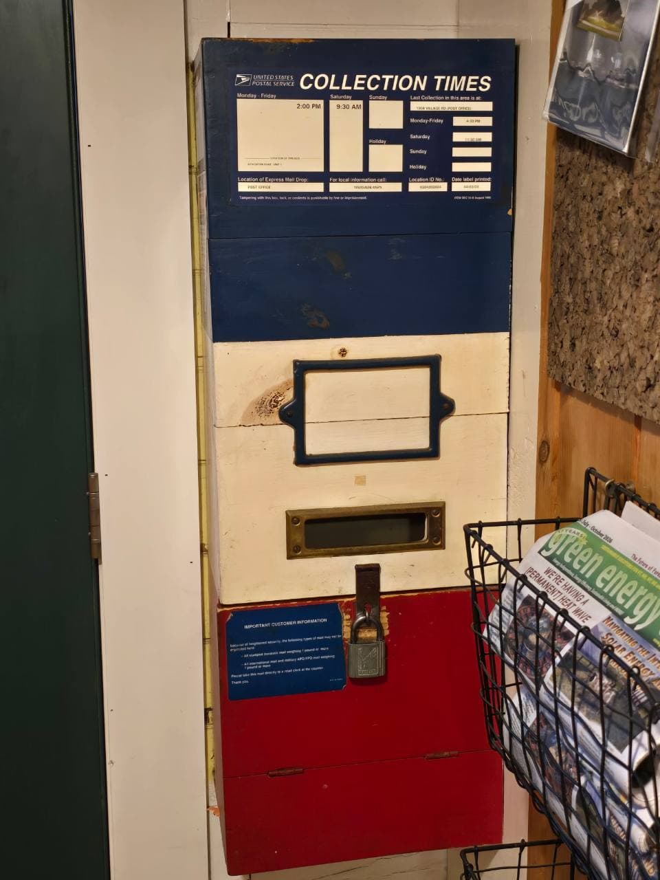 Post Office lobby mail slot beneath a USPS collection times sign