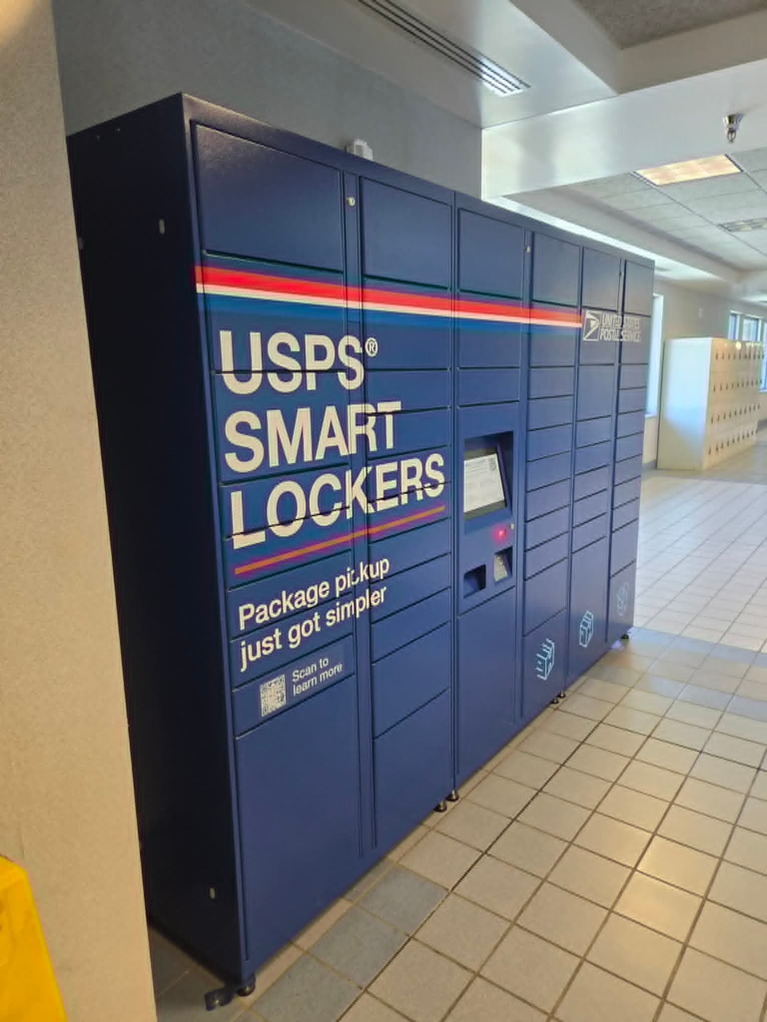 Blue USPS Smart Lockers inside a Post Office lobby