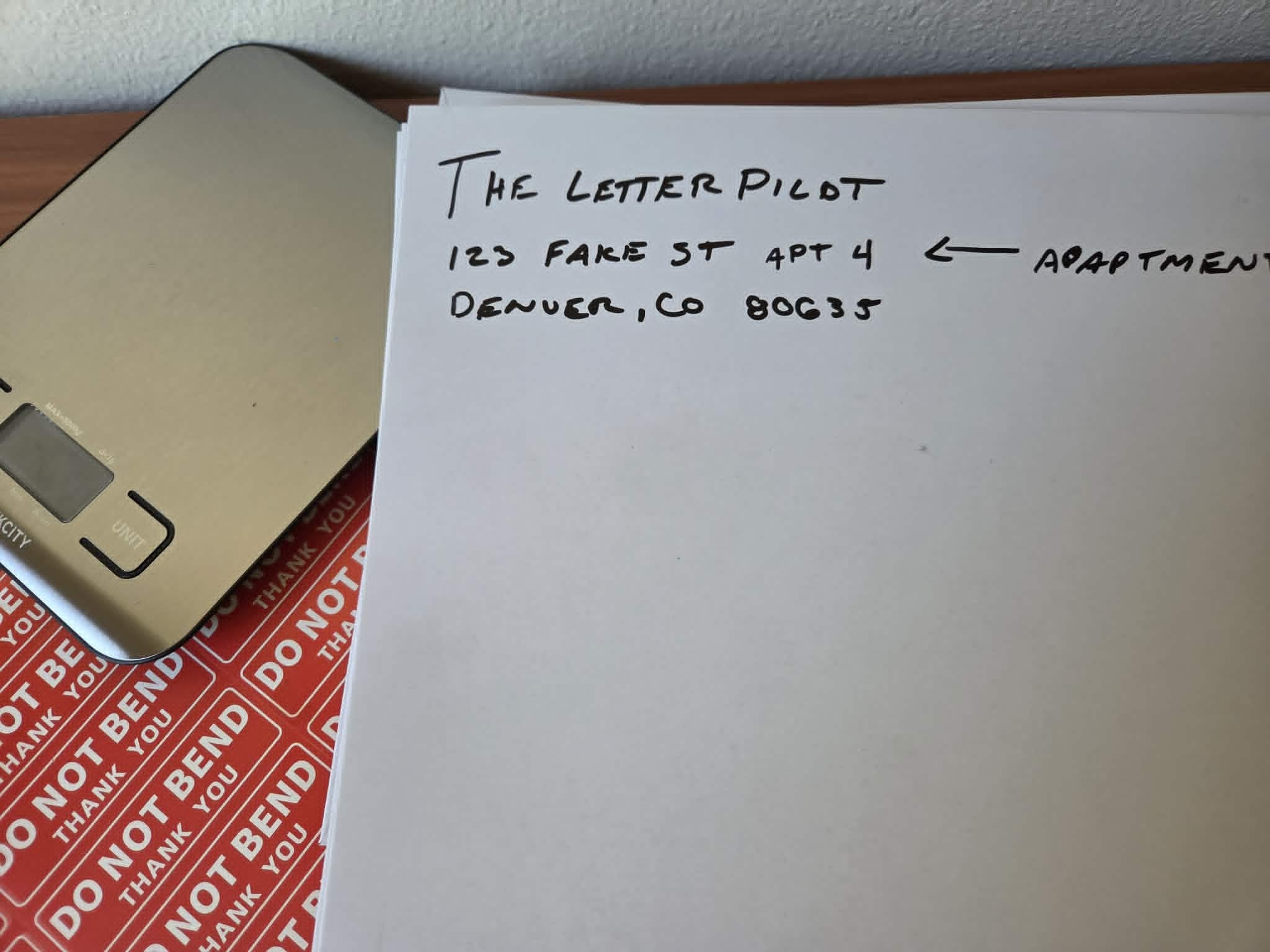 Handwritten envelope showing APT 4 on the same line as the street address