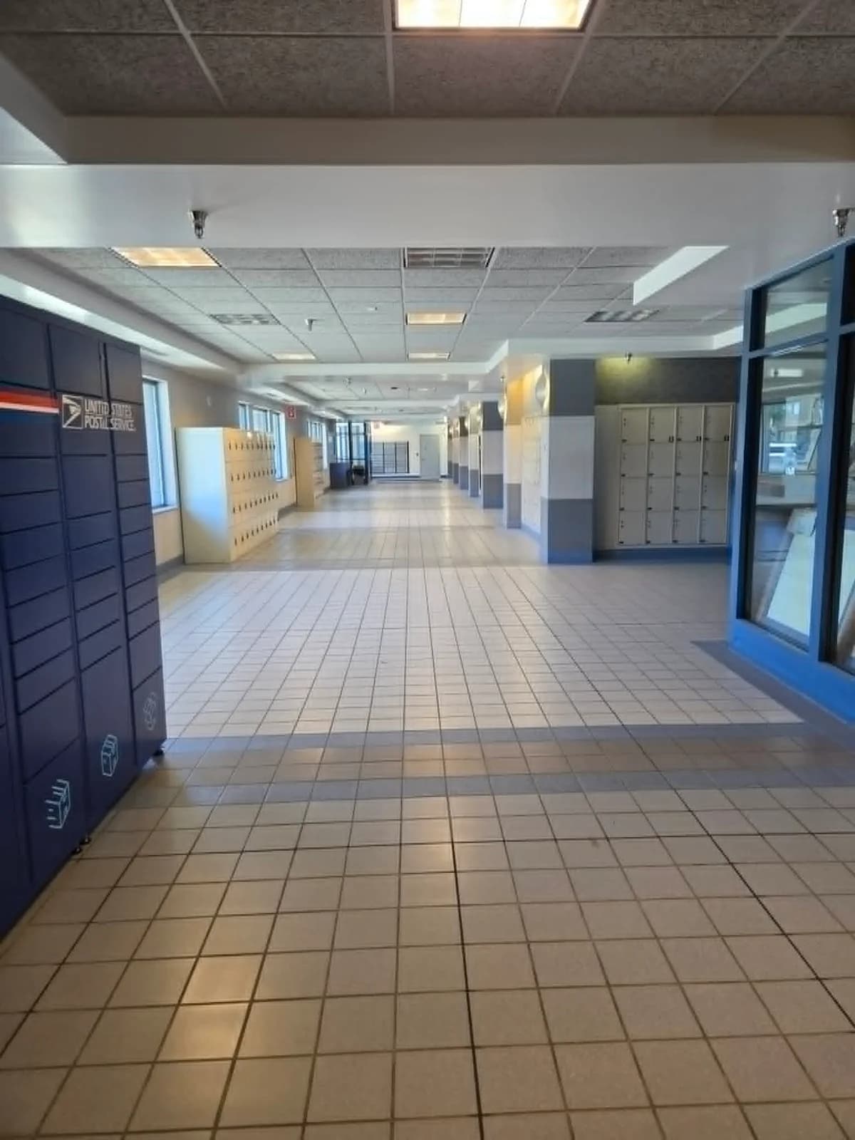 Modern USPS lobby with rows of PO Boxes and parcel lockers