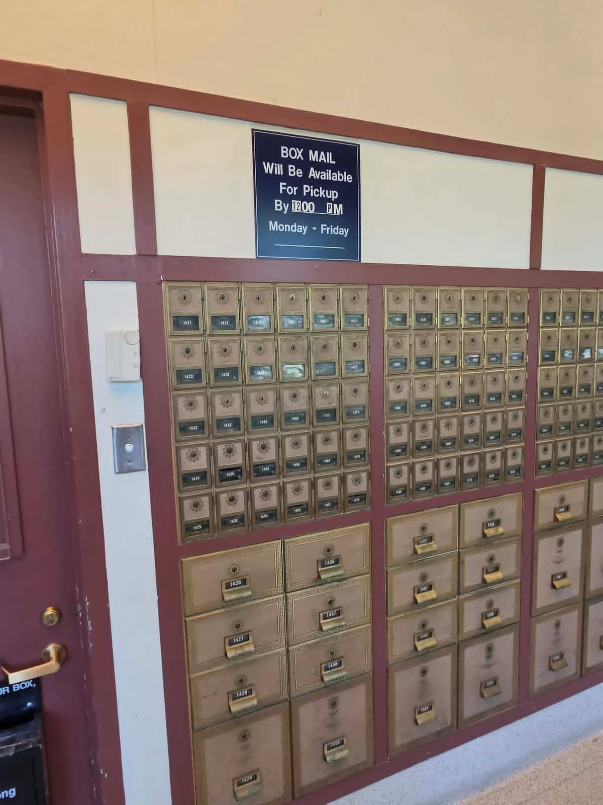 PO Boxes beneath a sign showing when box mail is available for pickup
