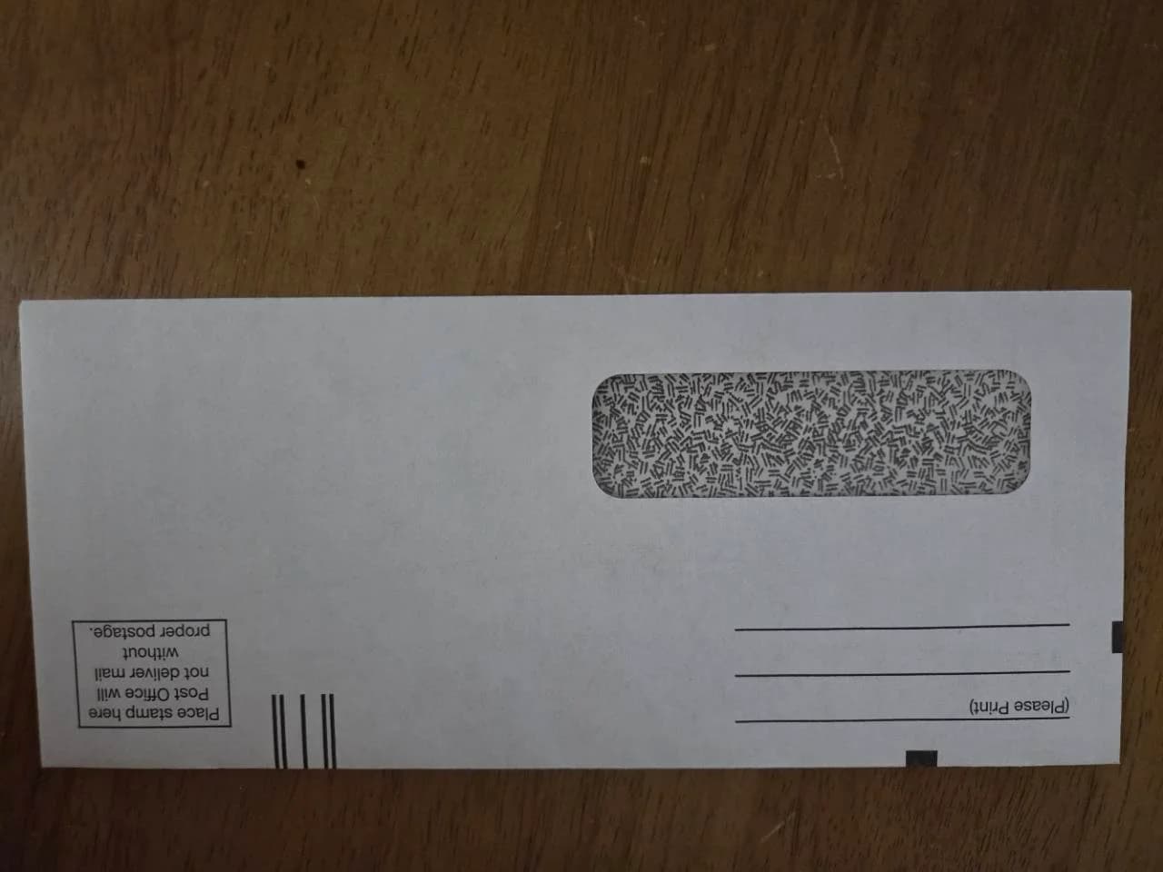 Window return envelope marked Place stamp here and Post Office will not deliver without proper postage